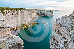 White chalk cliffs and natural arches of Etretat, Normandy, France. Atlantic sea coast in Normandie with famous rock