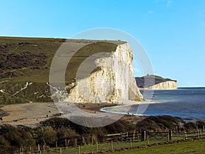 The white chalk cliffs of the Seven Sisters rise majestically above the sea in Sussex, UK