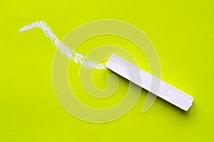 White chalk for drawing on a green background.