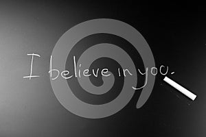 White chalk Write text on a blackboard