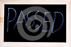 White chalk written on a blackboard