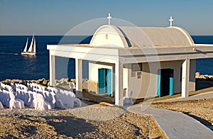 White chapel with sailing boat,cyprus photo