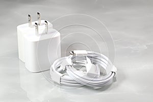 White charger adapters and white USB cables