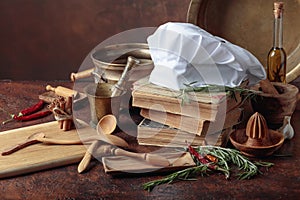 White chef`s hat and old cookbooks
