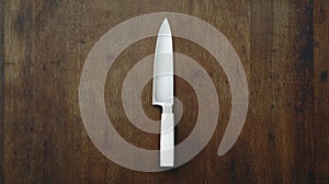 A white chef's knife with a black handle.