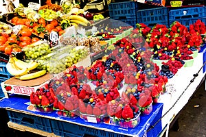 White cherries,strawberries,raspberries,blueberries and other different fruits and berries on the counter for sale.Healthy Eating