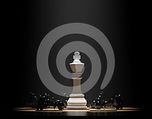 White chess king among lying black pawns on a chessboard. 3D rendering illustration.