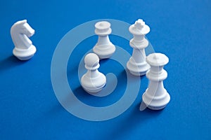 White chess pieces on a blue background. Abstract background.
