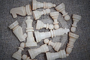 White chess pieces on burlap