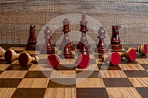 White chess pieces in submission position on the board