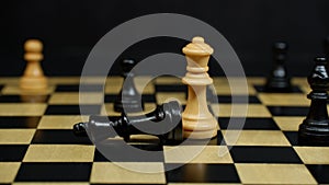 White chess queen piece has beaten black king piece