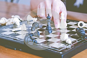 The white chess on women hand is fighting with black, think, discuss, committed, competition, winner, successful, dedicate concept
