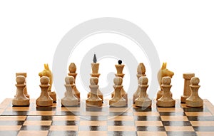 White chessmen on wooden chessboard