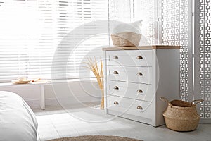 White chest of drawers in bedroom. Interior design