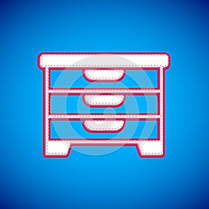 White Chest of drawers icon isolated on blue background. Vector