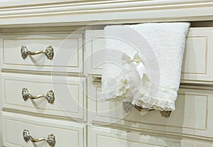 White chest of drawers with a towel