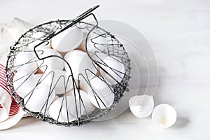 White chicken eggs in a basket.