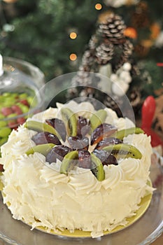 White chocolate cake with fresh fruits with Christmas decoration