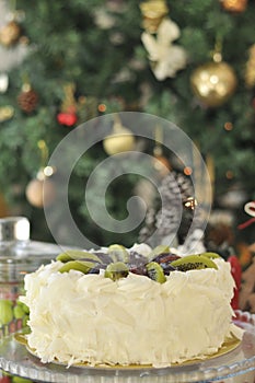 White chocolate cake with fresh fruits with Christmas decoration