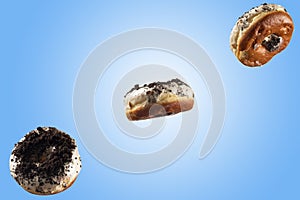 White chocolate glazed doughnut with chocolate sprinkle on top on blue background.