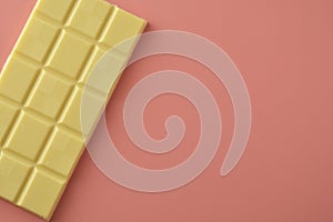 White chocolate isolated over pink background. Copy space