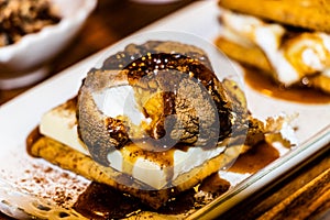 White chocolate and marshmallow smore covered in birch whiskey toffee sauce