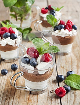 White chocolate and milk chocolate mousse with berries and meringue