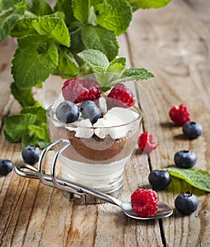 White chocolate and milk chocolate mousse with berries and meringue