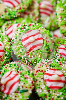 White chocolate peppermint kisses cookies decorated with Christmas holiday sprinkles and jimmies. Portrait orientation