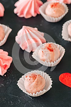 White chocolate strawberry truffles and pink meringue kisses on