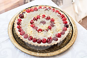 White chocolate tart with cherries and elder tree flowers