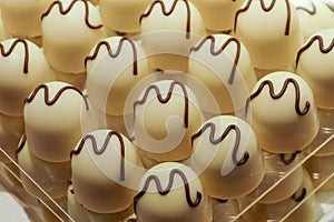 White chocolate truffle pralines close-up background