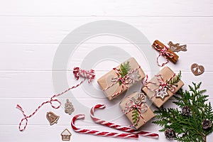 White christmas background. Framewith christmas gifts and candy cane, decorations , pine cones, fir branches