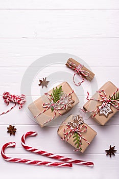 White christmas background. Framewith christmas gifts and candy cane, decorations , pine cones, fir branches