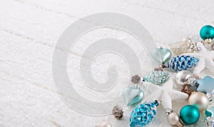 White christmas background with snow and balls in turquoise, blu