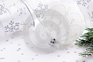 White Christmas ball,fir branch and ribbon.Christmas decoration