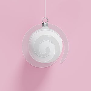 White Christmas ball ornament on pink background