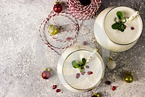 White Christmas cocktail coconut Mojito drink on festive background