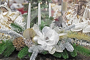 white christmas flower with candles and christmas tree branches.