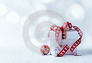 White Christmas gift with red ribbon