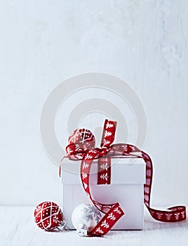 White Christmas gift with red ribbon