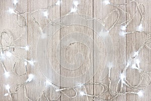 White Christmas lights frame over light gray wood