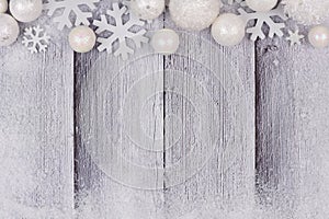 White Christmas ornament top border with snow on white wood