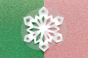 White Christmas paper snowflake on duoble colored backgound