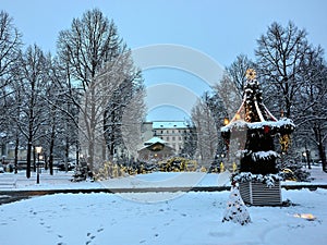 White Christmas in park by lighted nativity scene in spa town Bad Kissingen