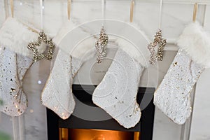 White Christmas socks hanging on fireplace