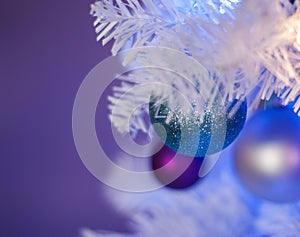 White Christmas tree with blue lights, white lights, turquoise ornament in front