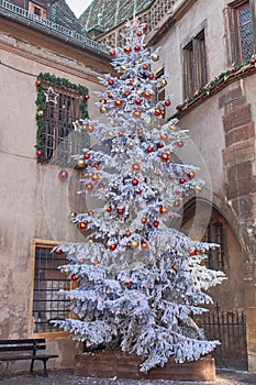 White Christmas tree decorated with colorful globes