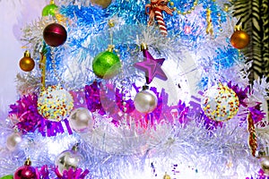 A white christmas tree decorated with colorful objects