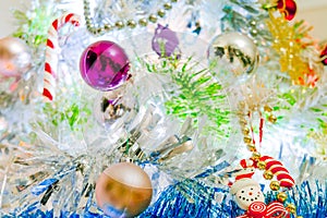 A white christmas tree decorated with colorful objects